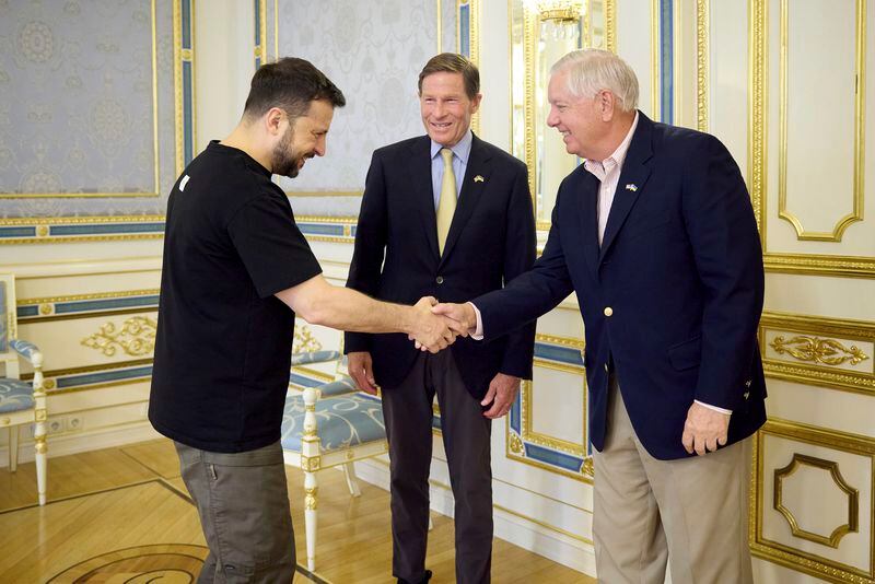 In this photo provided by the Ukrainian Presidential Press Office, Ukrainian President Volodymyr Zelenskyy, left, shakes hands with US Sen. Lindsey Graham (R-S.C.) as US Sen. Richard Blumenthal, D-Conn. Looks on in Kyiv, Ukraine, Monday, Aug. 12, 2024. (Ukrainian Presidential Press Office via AP)