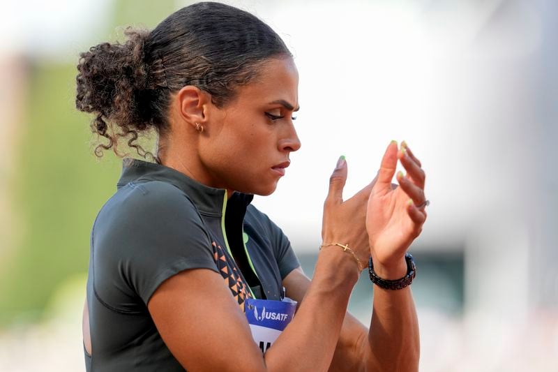 Sydney McLaughlin-Levrone prepares for the start of the women's 400-meter hurdles final during the U.S. Track and Field Olympic Team Trials, Sunday, June 30, 2024, in Eugene, Ore. It’s been 100 years since a Scottish runner famously refused to race on a Sunday at the Paris Olympics because of his Christian beliefs. American Olympic champion Sydney McLaughlin-Levrone, who broke her own world record at Olympic trials Sunday in the 400-meter hurdles, describes how Eric Liddell’s words about running to glorify God resonated with her in her new book, “Far Beyond Gold.” (AP Photo/George Walker IV)