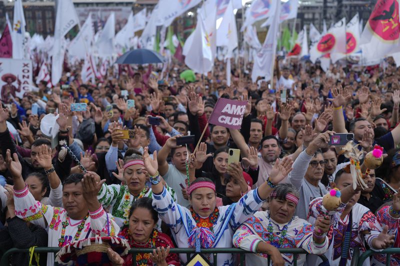 Supporters of President Claudia Sheinbaum attend a rally in the Zócalo, Mexico City's main square, on her inauguration day, Tuesday, Oct. 1, 2024. (AP Photo/Eduardo Verdugo)