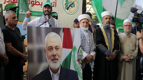 Hamas members attend a protest to condemn the killing of Hamas political chief Ismail Haniyeh, at al-Bass Palestinian refugee camp, in the southern port city of Tyre, Lebanon, Wednesday, July 31, 2024. Haniyeh, Hamas' political chief in exile who landed on Israel's hit list after the militant group staged its surprise Oct. 7 attacks, was killed in an airstrike in the Iranian capital early Wednesday. (AP Photo/Mohammed Zaatari)