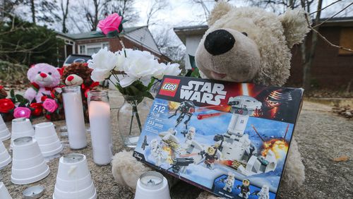 A memorial was placed on Jasper Street in Atlanta near where a boy was killed and a girl was injured in a pit bull attack on their way to school. The mother of the boy, Logan Braatz, filed suit against LifeLine Animal Project, Fulton County’s animal control provider. AJC FILE PHOTO