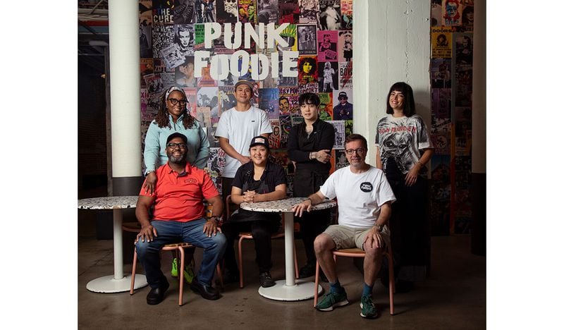 Punk Foodie founder Sam Flemming (front row right) is seen with pop-up chefs (from left) Jimmie Jackson and Phya J. of JJC Jimmie Jerk Chicken, Fu-Mao Sun of Mighty Hans, Jess Kim (center seated) and Jun Park (standing) of Ganji and designer Alynn Martinez. Martha Williams for The Atlanta Journal-Constitution  