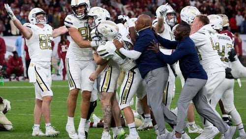 Georgia Tech players celebrate after the Yellow Jackets defeated Florida State at the Aviva Stadium in Dublin, Saturday, Aug. 24, 2024. (AP Photo/Peter Morrison)