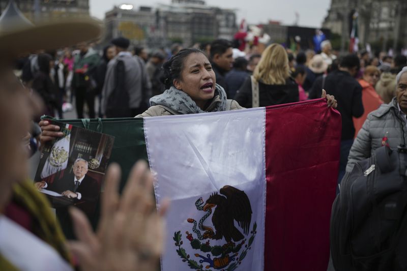 Supporters of Mexican President Andres Manuel Lopez Obrador gather outside the National Palace where he holds his last morning press conference, "La Mañanera," in Mexico City, Monday, Sept. 30, 2024. (AP Photo/Eduardo Verdugo)