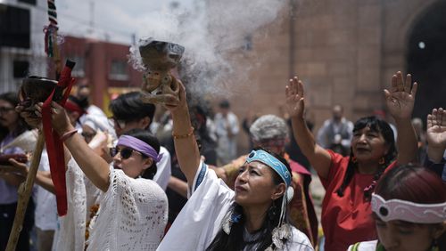 Residents and members of an Amaxac Indigenous organization perform a ceremony commemorating the 503rd anniversary of the fall of the Aztec empire's capital, Tenochtitlan, in Mexico City, Tuesday, Aug. 13, 2024. (AP Photo/Eduardo Verdugo)