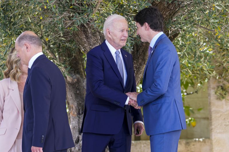 FILE - U.S. President Joe Biden, center, talks to Canada's Prime Minister Justin Trudeau, right, during a G7 world leaders summit at Borgo Egnazia, Italy, June 13, 2024. The U.S. and Canada said Thursday, July 11, that they have agreed to update a six-decade-old treaty that governs the use of one of North America’s largest rivers, the Columbia, with implications for electricity prices, irrigation, flood control and imperiled salmon runs. (AP Photo/Luca Bruno, File)