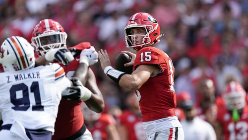 Georgia quarterback Carson Beck (15) throws from the pocket in the first half of an NCAA college football game against Auburn Saturday, Oct. 5, 2024, in Athens, Ga. (AP Photo/John Bazemore)