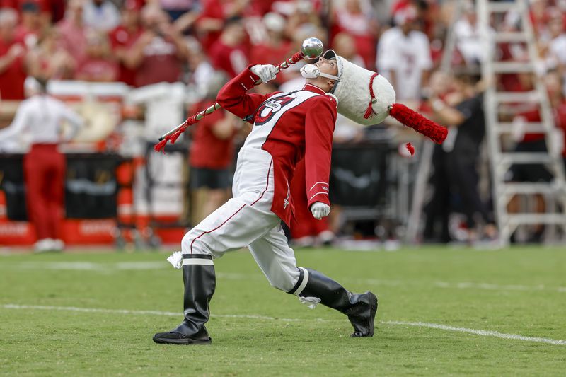 The Pride of Oklahoma Marching Band drum major performs before an NCAA college football game against Temple, Friday, Aug. 30, 2024, in Norman, Okla. (AP Photo/Alonzo Adams)