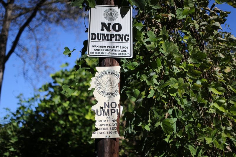 Old and new signs against illegal dumping on Alvin Drive NW and the surrounding area on October 20, 2015. Ben Gray / bgray@ajc.com