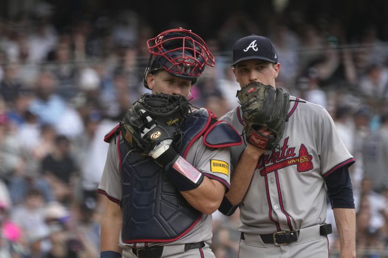 Atlanta Braves catcher Sean Murphy, left, and pitcher Max Fried talk on the mound after New York Yankees' Trent Grisham hits a single during the sixth inning of a baseball game, Sunday, June 23, 2024, in New York. (AP Photo/Pamela Smith)