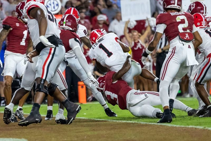 Georgia running back Trevor Etienne (1) scores a touchdown on a run over Alabama defensive back Keon Sabb (3) during the first half of an NCAA college football game, Saturday, Sept. 28, 2024, in Tuscaloosa, Ala. (AP Photo/Vasha Hunt)