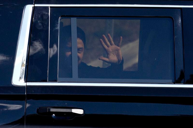 Ukrainian President Volodymyr Zelenskyy waves from the back seat of a U.S. Secret Service vehicle as his motorcade departs the Wilkes-Barre/Scranton International Airport in Pittston Twp., Pa. en route to the Scranton Army Ammunition Plant in Scranton, Pa. on Sunday, Sept. 22, 2024. (Christopher Dolan / The Times-Tribune via AP)/The Times-Tribune via AP)