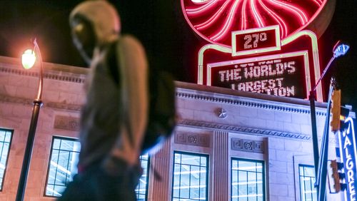 Derrick Harrison walks past the Coca-Cola temperature sign near Five Points in downtown Atlanta on the way to work on March 16, 2017.