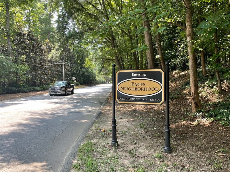 A sign greeting those entering the woodsy and high-end Paces neighborhood in west Buckhead lets drivers know they very well might be watched. Photo by Bill Torpy