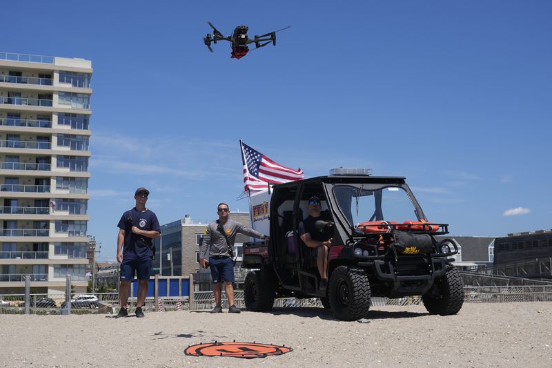 An FDNY drone pilot launches a drone at Rockaway Beach in New York, Thursday, July 11, 2024. A fleet of drones patrolling New York City’s beaches for signs of sharks and struggling swimmers is drawing backlash from an aggressive group of seaside residents: local shorebirds. Since the drones began flying in May, flocks of birds have repeatedly swarmed the devices, forcing the police department and other city agencies to adjust their flight plans. (AP Photo/Seth Wenig)