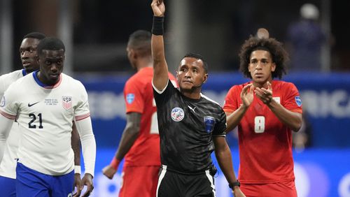 Referee Ivan Barton shows the red card to Tim Weah of the United States, left, during a Copa America Group C soccer match against Panama in Atlanta, Thursday, June 27, 2024. (AP Photo/Mike Stewart)