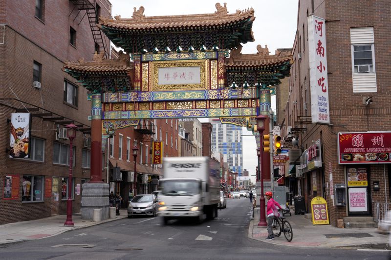 People pass through the Chinatown neighborhood of Philadelphia, Wednesday, Sept. 18, 2024. (AP Photo/Matt Slocum)