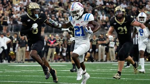 Mississippi running back Henry Parrish Jr. (21) runs for a touchdown against Wake Forest defensive back Rushaun Tongue (6) during the first half of an NCAA college football game in Winston-Salem, N.C., Saturday, Sept. 14, 2024. (AP Photo/Chuck Burton)