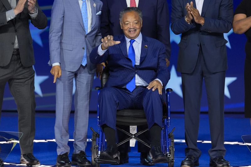 Rev. Jesse Jackson waves during the Democratic National Convention Monday, Aug. 19, 2024, in Chicago. (AP Photo/J. Scott Applewhite)