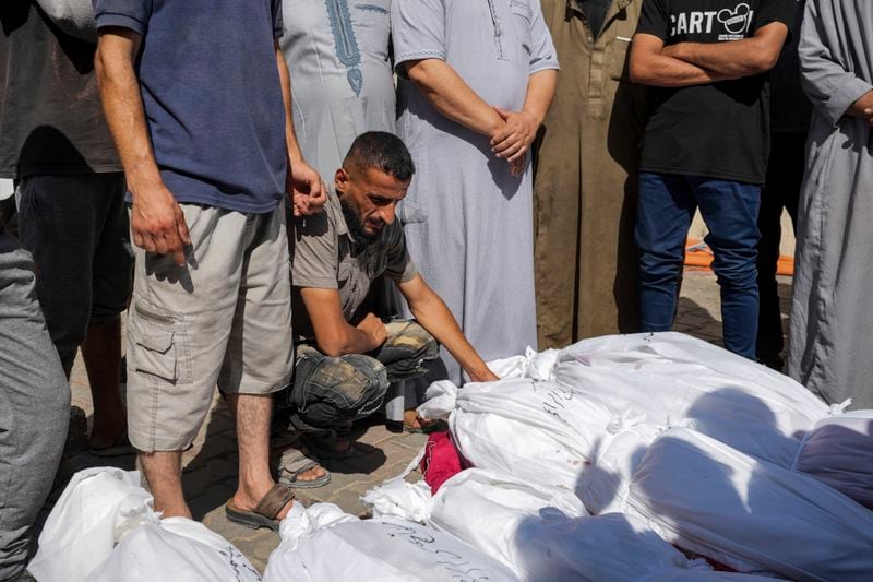 Palestinians mourn their relatives killed in the Israeli bombardment of the Gaza Strip in a hospital in Deir al Balah on Tuesday, June 18, 2024. (AP Photo/Abdel Kareem Hana)