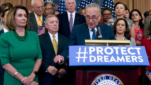 Senate Minority Leader Chuck Schumer of N.Y., accompanied by House Minority Leader Nancy Pelosi of Calif., left, and other Democratic members of the House and Senate, speaks during a Capitol Hill press conference in Washington earlier this month. AP/Jose Luis Magana