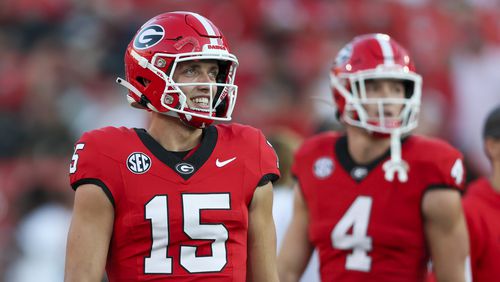 Georgia quarterback Carson Beck (15) talks with teammates as tight end Oscar Delp (4) is shown before their game against UAB at Sanford Stadium, Saturday, September 23, 2023, in Athens, Ga. (Jason Getz / Jason.Getz@ajc.com)