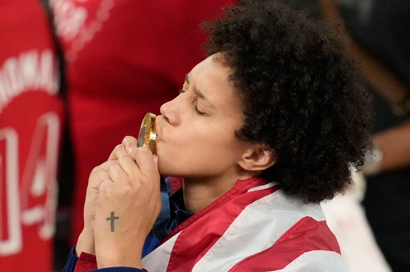 United States' Brittney Griner kisses her gold medal at Bercy Arena at the 2024 Summer Olympics, Sunday, Aug. 11, 2024, in Paris, France. (AP Photo/Michael Conroy)