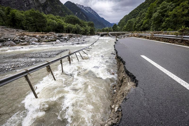 The highway A13 between Lostallo and Soazza is seen destroyed by the force of the Moesa river, caused by heavy rain in the Misox valley, in Lostallo, southern Switzerland, Sunday, June 23, 2024. Authorities in Switzerland say rescuers have found the body of one of three people who had gone missing on Saturday after massive thunderstorms and rainfall in the southeast of the county caused a rockslide. (Michael Buholzer/Keystone via AP)