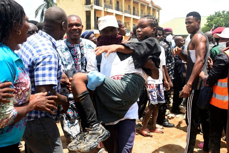 A student is rescued from the rubble of a collapsed two-storey building in Jos, Nigeria, Friday, July, 12, 2024. At least 12 students have been killed after a school building collapsed and trapped them in northern Nigeria, authorities said on Friday. (AP Photos)