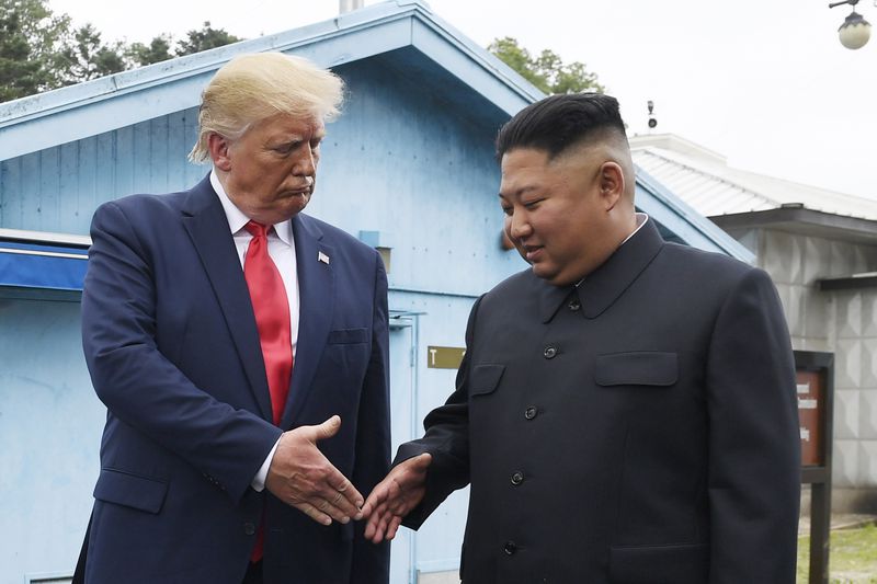 FILE - North Korean leader Kim Jong Un, right, and U.S. President Donald Trump prepare to shake hands at the border village of Panmunjom in the Demilitarized Zone, South Korea, June 30, 2019. (AP Photo/Susan Walsh, File)