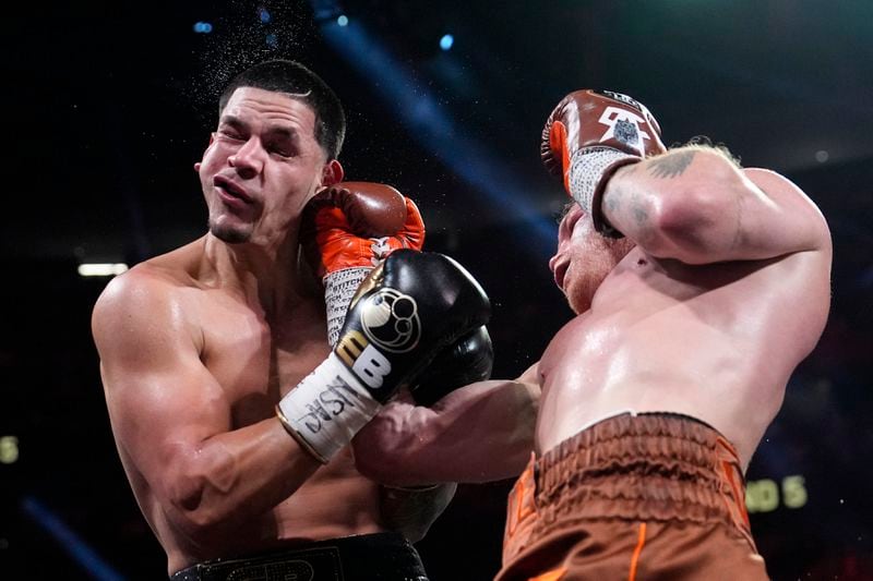 Canelo Alvarez hits Edgar Berlanga in a super middleweight title bout Saturday, Sept. 14, 2024, in Las Vegas. (AP Photo/John Locher)