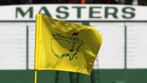 The Masters golf pin flag on the ninth green is seen with the scoreboard along the first fairway in the background at Augusta National Golf Club on Sunday, April 4, 2021, in Augusta, Georgia. (Curtis Compton/Atlanta Journal-Constitution/TNS)