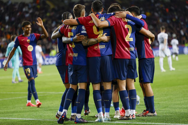 Barcelona's Robert Lewandowski, centre, celebrates after scoring his side's fourth goal during the Champions League soccer match between Barcelona and Young Boys at the Lluis Companys Olympic Stadium in Barcelona, Spain, Tuesday, Oct. 1, 2024. (AP Photo/Joan Monfort)