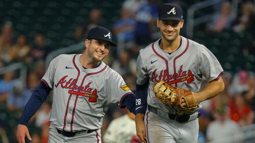 Atlanta Braves relief pitcher Luke Jackson, left, smiles appreciatively to first baseman Matt Olson after the latter made a diving catch to end the seventh inning of a baseball game against the Minnesota Twins, Wednesday, Aug. 28, 2024, in Minneapolis. (AP Photo/Bruce Kluckhohn)