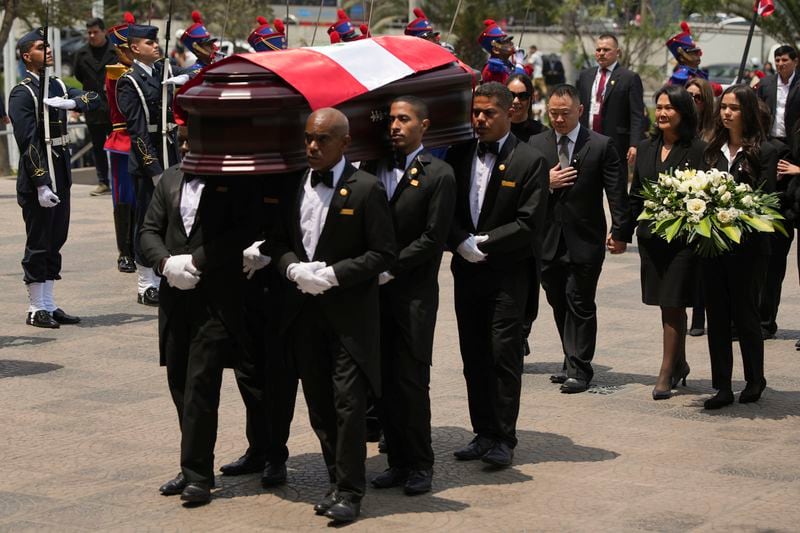 Keiko Fujimori and her brother Kenji follow pallbearers carrying the coffin of their father, former President Alberto Fujimori to a museum for his wake in Lima, Peru, Thursday, Sept. 12, 2024. (AP Photo/Guadalupe Pardo)