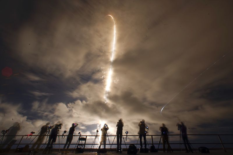 A time exposure shows photographers as they document the SpaceX Falcon 9 rocket with a crew of four as it launches from pad 39A at the Kennedy Space Center in Cape Canaveral, Fla., Monday, Sept. 9, 2024. (AP Photo/John Raoux)