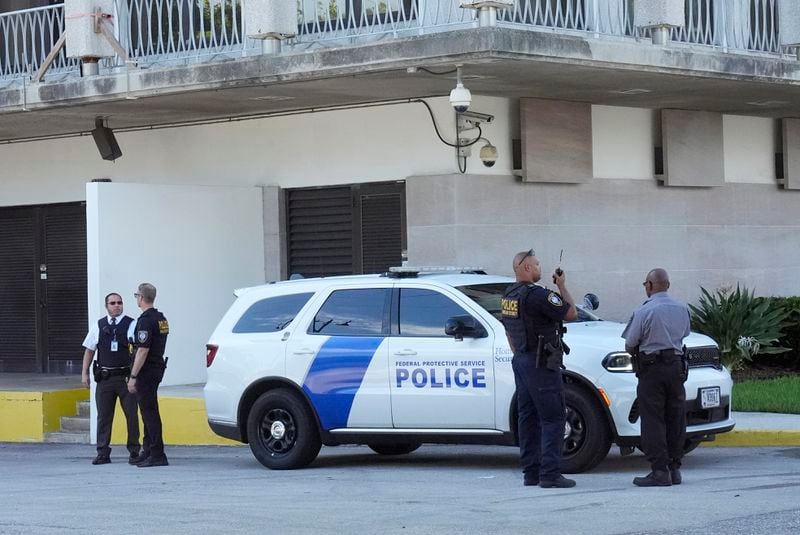 Department of Homeland Security officers patrol outside the Paul G. Rogers Federal Building and U.S. Courthouse, where a man suspected in an apparent assassination attempt targeting former President Donald Trump, was charged with federal gun crimes, Monday, Sept. 16, 2024, in West Palm Beach, Fla. (AP Photo/Wilfredo Lee)