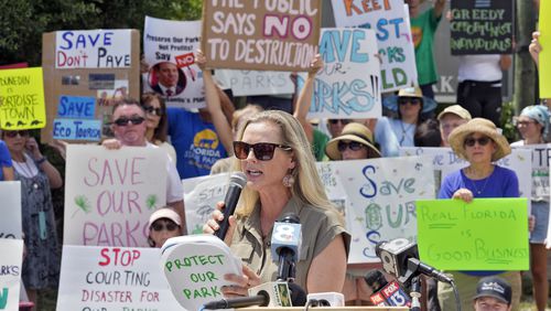 Democratic Florida State Rep. Lindsay Cross speaks to supporters against development at Florida state parks outside the entrance to Honeymoon Island State Park Tuesday, Aug. 27, 2024, in Dunedin, Fla. (AP Photo/Chris O'Meara)