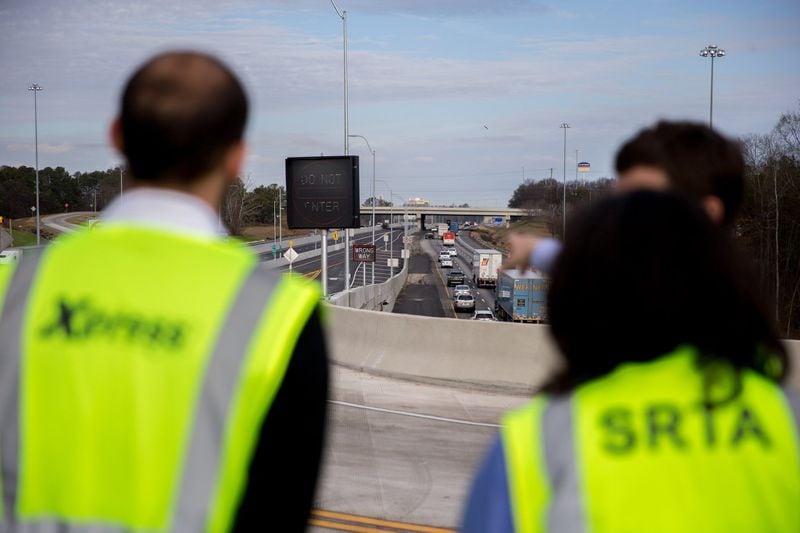 SRTA workers stand on part of the new reversible lanes at the Jonesboro Road exit on I-75, Thursday, Jan. 19, 2017, in McDonough, Ga. BRANDEN CAMP/SPECIAL