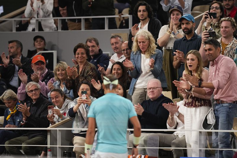 Spectators applaud Spain's Rafael Nadal during the first round match of the French Open tennis tournament against Germany's Alexander Zverev at the Roland Garros stadium in Paris, Monday, May 27, 2024. (AP Photo/Thibault Camus)