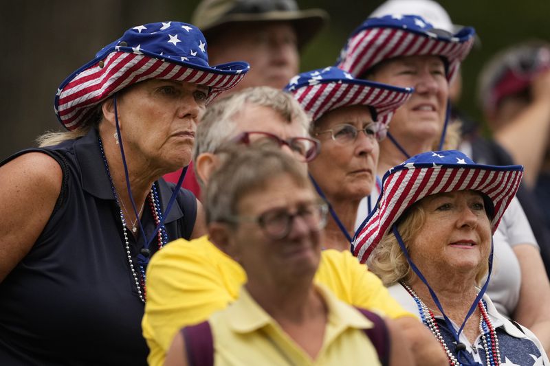 Fans watch from the 11th fairway during a Solheim Cup golf tournament foursomes match at Robert Trent Jones Golf Club, Friday, Sept. 13, 2024, in Gainesville, VA. (AP Photo/Matt York)