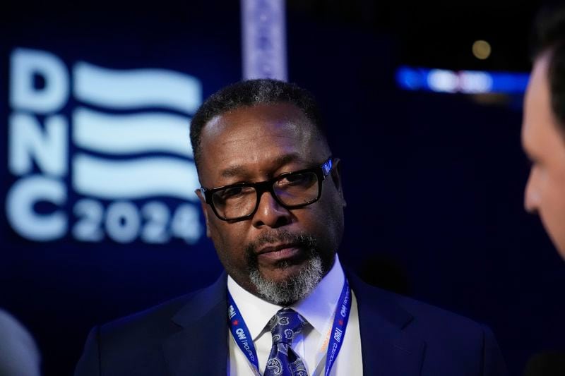 Actor Wendell Pierce peaks to reporters before the Democratic National Convention Tuesday, Aug. 20, 2024, in Chicago. (AP Photo/Brynn Anderson)