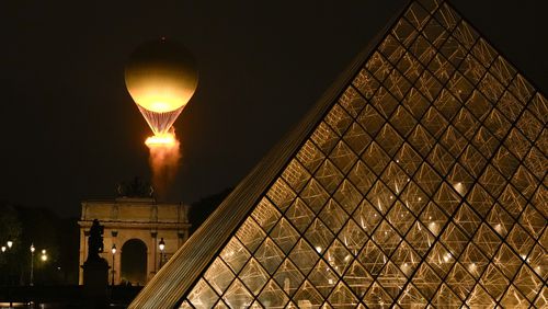 The Olympic Flame rises on a balloon after being lit in Paris, France, during the opening ceremony of the 2024 Summer Olympics, Friday, July 26, 2024. (AP Photo/Francisco Seco)