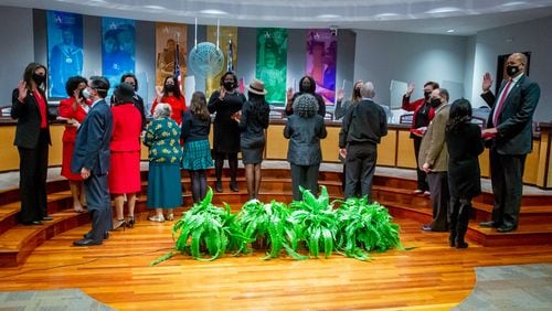 The Atlanta Board of Education, shown here during a January swearing-in ceremony, approved a preliminary policy to address complaints about how divisive concepts are taught in schools. STEVE SCHAEFER/AJC FILE PHOTO