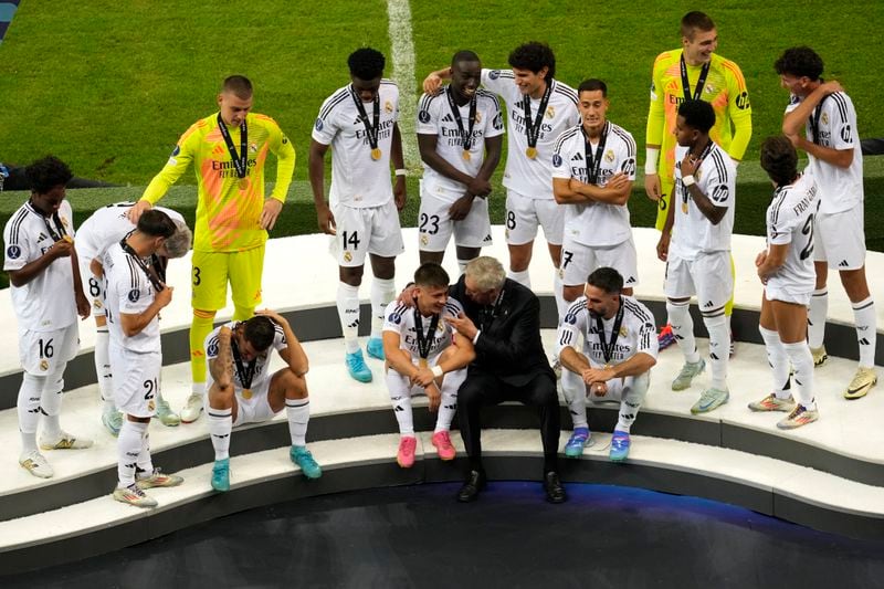 Real Madrid's head coach Carlo Ancelotti, center, speaks with his player Arda Guler at the end of the UEFA Super Cup Final soccer match between Real Madrid and Atalanta at the Narodowy stadium in Warsaw, Poland, Wednesday, Aug. 14, 2024. Real Madrid won 2-0. (AP Photo/Darko Vojinovic)