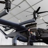 Douglas Hayes, staff manufacturing project manager, and Joshua Alconaba, senior production specialist, appear by Archer’s Midnight electric vertical take-off and landing (eVTOL) aircraft at DeKalb-Peachtree Airport in Atlanta on Thursday, July 25, 2024. (Arvin Temkar / AJC)