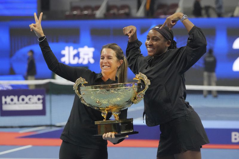 Coco Gauff of the United States celebrates with her trainer Mery Vago after defeating Karolina Muchova of Czech Republic in the women's singles final match at the China Open tennis tournament at the National Tennis Center in Beijing, Sunday, Oct. 6, 2024. (AP Photo/Achmad Ibrahim)