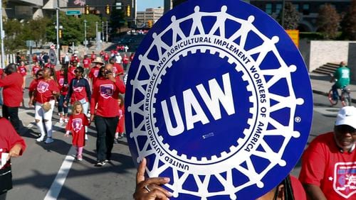 FILE - United Auto Workers members walk in the Labor Day parade in Detroit, Sept. 2, 2019. (AP Photo/Paul Sancya, File)