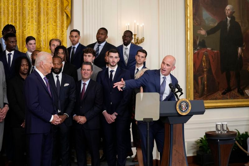 President Joe Biden, left, listens as University of Connecticut Huskies Men's basketball team head coach Dan Hurley, right, speaks during an event in the East Room of the White House in Washington, Tuesday, Sept. 10, 2024, to welcome the Huskies and celebrate their 2023-2024 NCAA championship season. (AP Photo/Susan Walsh)