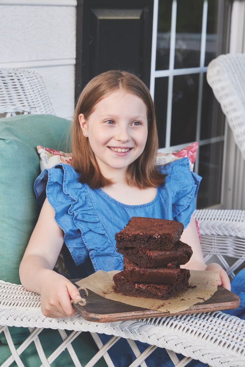 Josefina Gracey, one of Cristina Kisner's daughters, poses with a plate of Kisner's Superpowerful Brownies. (Courtesy of Jimena Agois)